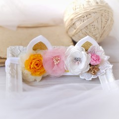 Handmade flowers as headband hair accessory with cat or kitty ears as decoration in soft pastel colors
