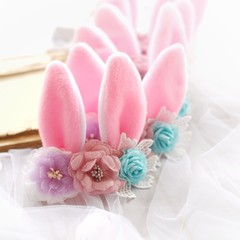 Handmade flowers as headband hair accessory with bunny or rabbit ears as decoraiton in soft pastel colors
