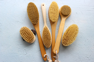 Brushes for dry body massage. wooden brushes with natural bristles on a light background