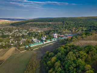 Flight over a christian monastery surrounded by autumn forest. Kurky monastery, Moldova republic of. © Igor Syrbu