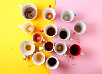 Obraz na płótnie Canvas Group of different empty cups of coffee on yellow and pink background. Top view,flat lay,copy space.
