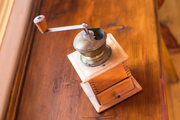 Vintage coffee grinder - old wooden manual coffee grinder in the kitchen