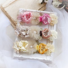 Headband flower with pastel color made out of flower fabric on a white photo frame. The handmade floral is great for hair accessories with its colorful flower and beautiful for hair band.