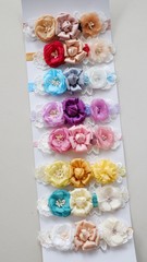 Obraz na płótnie Canvas Handmade headband flower made out of flower fabric in beautiful pastel colors. The handmade floral is great for hair accessories with its colorful flower and beautiful for hair band.