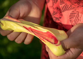 children's hands with self-made slime, slime making at a birthday party, close up of a little child is hand playing a slime