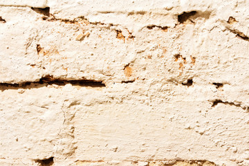 The texture of a brick wall painted with white paint.