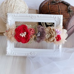 Headband flower with pastel color made out of flower fabric on white photo frame. The handmade floral is great for hair accessories with its colorful flower and beautiful for hair band.