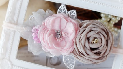 Handmade flower headband hair accessory made out of fabric flowers in beautiful soft pink and gray colors