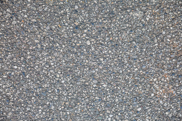 Stony surface of asphalt. Tarmac grey grainy road. Texture Background. Top view