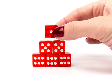 Transparent and red glass dices in hand isolated on white background.