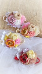 Obraz na płótnie Canvas Handmade flower as headband hair accessory made out of fabric flowers in beautiful pastel colors