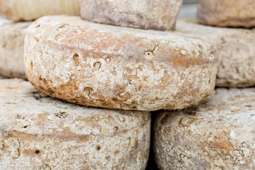 French Comte cheese wheel crusts aging for months