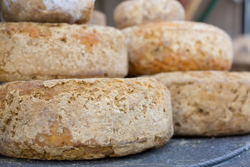 French Comte cheese wheel crusts aging for months