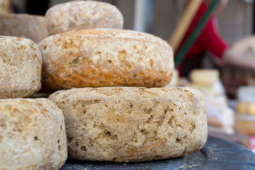 French Comte cheese wheel crusts aging for months