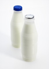 Bottles of Milk against White Background