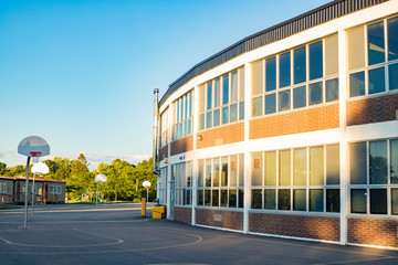 School building and school yard with basketball court