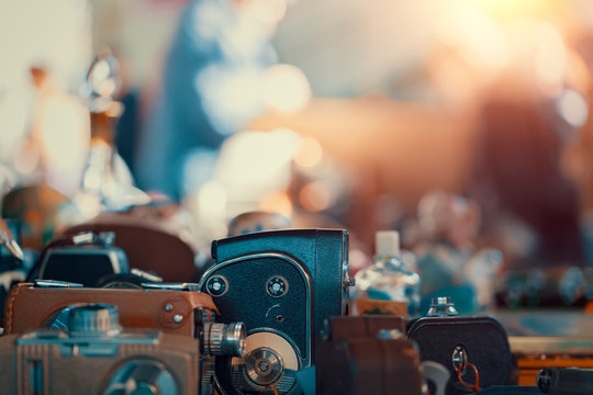 Old fashioned manual cameras on the countertop at sunday flea market. Vintage furniture in antique bazaar - Powered by Adobe