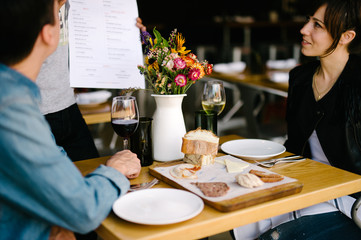 Couple out to eat on a date hearing about today's specials