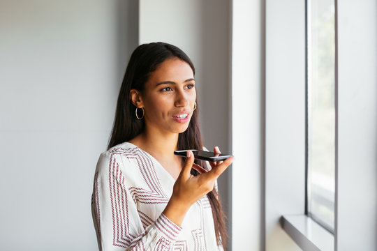 Young event planner recording audio message