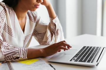 Crop event planner using laptop at desk