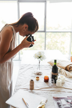 Event planner taking pictures of decorated table
