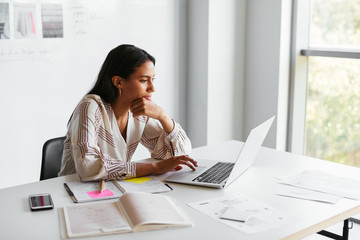 Event planner using laptop in office