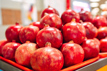 Fototapeta na wymiar Juicy and ripe pomegranate whole with flower. Ruby natural pomegranate garnet fruit