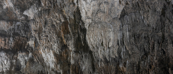 Gray stalactite wall texture in the cave