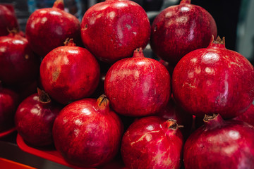 Juicy and ripe pomegranate whole with flower. Ruby natural pomegranate garnet fruit