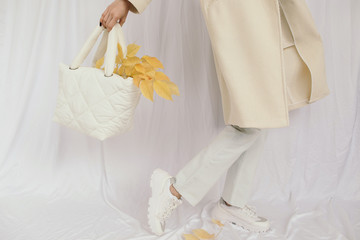 Crop lady with autumn leaves