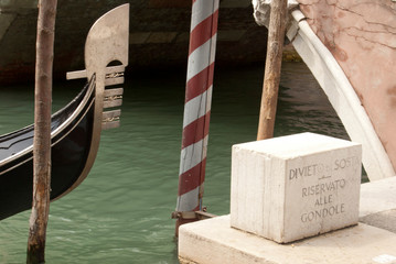 
Gondola parked with a stone on which it is written: "no parking, parking reserved for gondolas"