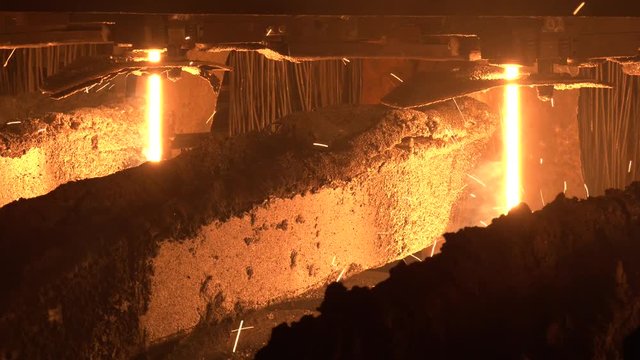 Mettallurgical equipment. Steel Billets at Torch Cutting. Red hot steel metal billets after molten steel casting. The video was shot hand-held while driving to the object.
