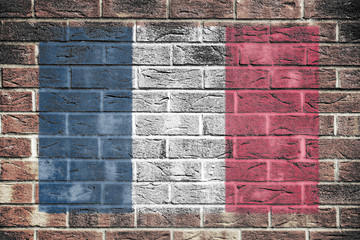 France flag on old brick wall background