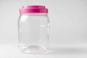 Empty wide clear plastic bottle. White Background.