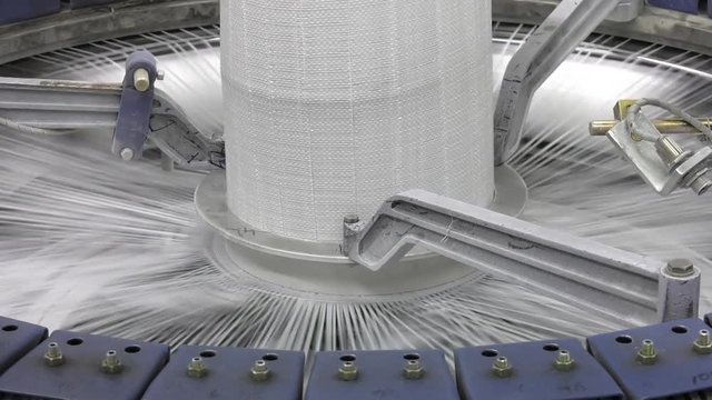 Production of white polypropylene flat yarn for the production of industrial bags. Allison-circular loom woven bag machine. Production of polypropylene sleeves. Shuttle.
