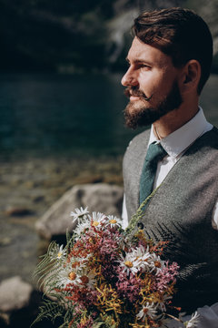Gorgeous husband with bouquet waiting for his wife.
