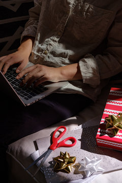 Hands of anonymous woman Christmas shopping online on Black Friday.