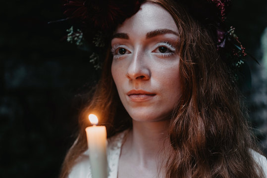 Bridal portraits of a beautiful red haired woman wearing a flower crown