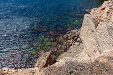 Seascape - sheer cliffs against which sea waves beat
