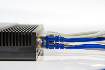 Network switch and ethernet cables close-up. UTP cables connected to a Patch Panel. Data center...