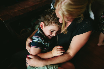 mom cuddles children in their home