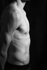 Fototapeta na wymiar Medellín, Antioquia / Colombia. September 07, 2019. Muscular male torso on a black background