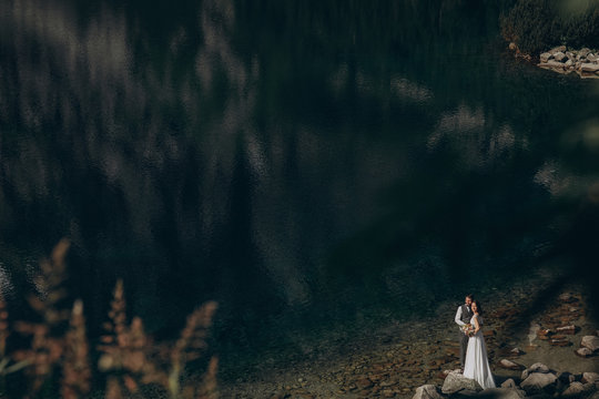 Young couple spending their time near lake.