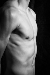 Medell&iacute;n, Antioquia / Colombia. September 07, 2019. Muscular male torso on a black background
