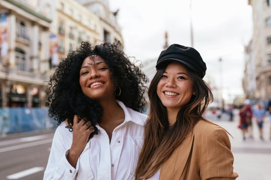 African-american and asian friends walking around the city