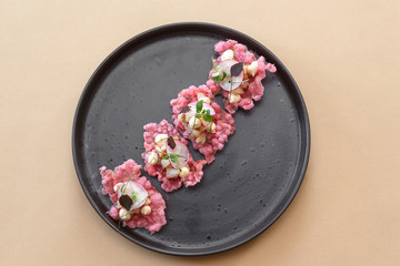 Smoked whitefish on tapioca chips, beige background, top view