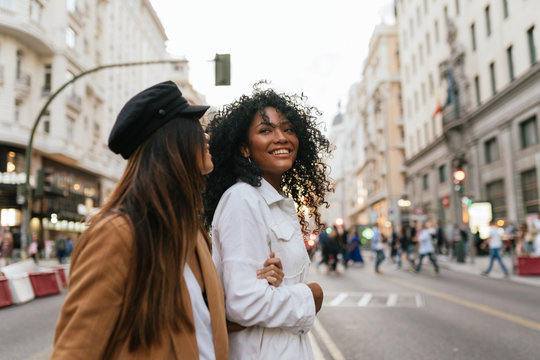 african american and chinese woman walking in the city