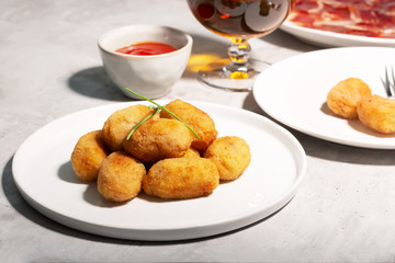 Tapas croquettes, traditional Spanish or French snack. Concrete background