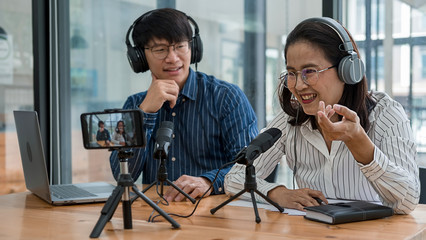 Young business people recording a podcast in a studio