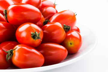 Close-up of fresh cherry tomatoes on a white dish